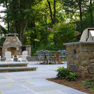 Backyard stone patio, outdoor fireplace and kitchen in Mendham, New Jersey