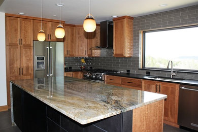 Inspiration for a l-shaped porcelain tile eat-in kitchen remodel in Other with an undermount sink, granite countertops, green backsplash, porcelain backsplash and an island