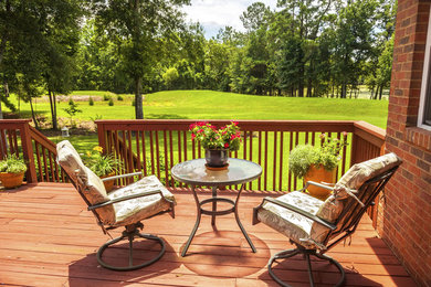 Example of a mid-sized classic backyard patio design in Houston with decking and no cover