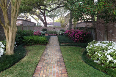 Design ideas for a traditional courtyard brick garden path in Houston for spring.