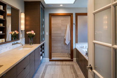 Mid-sized transitional master wet room bathroom in Baltimore with furniture-like cabinets, dark wood cabinets, an undermount tub, a one-piece toilet, beige tile, stone tile, grey walls, marble floors, an undermount sink, limestone benchtops, beige floor and an open shower.