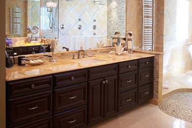 Large traditional master bathroom in Other with raised-panel cabinets, dark wood cabinets, an open shower, a one-piece toilet, beige tile, matchstick tile, beige walls, porcelain floors, an undermount sink and marble benchtops.