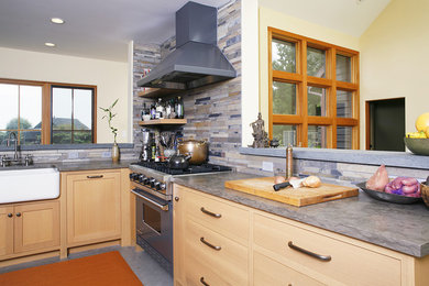 Example of a large mountain style u-shaped concrete floor and gray floor eat-in kitchen design in San Francisco with a farmhouse sink, light wood cabinets, stainless steel appliances, shaker cabinets, concrete countertops, beige backsplash, matchstick tile backsplash and a peninsula