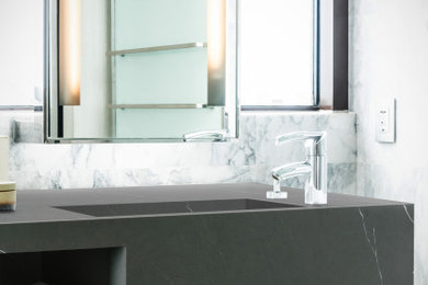 Idée de décoration pour une salle de bain design avec un plan de toilette en quartz modifié et un plan de toilette gris.