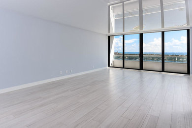 Example of a mid-sized trendy open concept porcelain tile and beige floor living room design in Miami with gray walls, no fireplace and no tv