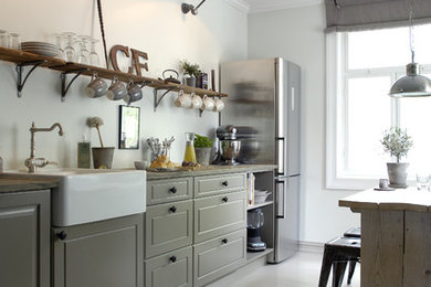 Photo of a country eat-in kitchen in Other with raised-panel cabinets, grey cabinets, stainless steel appliances, quartz benchtops and painted wood floors.