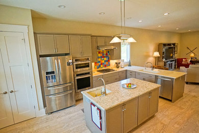 Inspiration for a mid-sized coastal l-shaped light wood floor open concept kitchen remodel in Charleston with an undermount sink, beaded inset cabinets, beige cabinets, stainless steel appliances and an island
