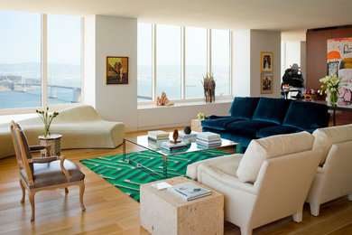 Inspiration for a mid-sized modern loft-style living room in San Francisco with white walls and light hardwood floors.