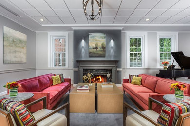 Example of a large trendy open concept laminate floor and brown floor living room design in DC Metro with gray walls, a standard fireplace, a stone fireplace and a wall-mounted tv