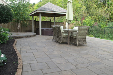 Inspiration for a large backyard concrete paver patio remodel in Ottawa