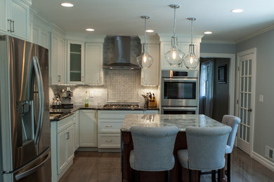 Eat-in kitchen - traditional l-shaped porcelain tile and brown floor eat-in kitchen idea in New York with an undermount sink, recessed-panel cabinets, white cabinets, granite countertops, multicolored backsplash, subway tile backsplash, stainless steel appliances and an island