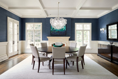 Dining room - traditional medium tone wood floor, brown floor, coffered ceiling and wallpaper dining room idea in Chicago with blue walls, a standard fireplace and a stone fireplace