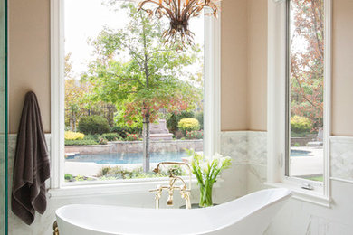 Example of a large transitional master white tile and porcelain tile mosaic tile floor bathroom design in Other with glass-front cabinets, white cabinets, a bidet, beige walls, an undermount sink and marble countertops
