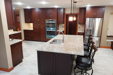 Design ideas for a modern kitchen in Orlando with shaker cabinets, medium wood cabinets and porcelain floors.