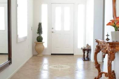 Photo of a mediterranean entryway in Los Angeles with travertine floors.