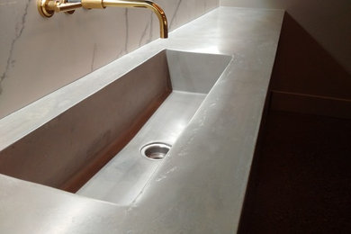 Inspiration for a mid-sized industrial basement remodel in Toronto with beige walls