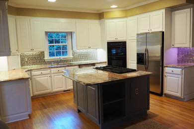 Inspiration for an u-shaped kitchen remodel in Raleigh with an island