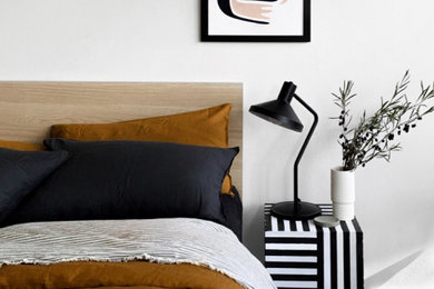 Inspiration for a small modern master bedroom in Gold Coast - Tweed with black floor.