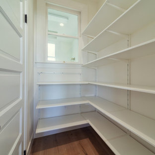 Photo of a mid-sized victorian kitchen pantry in San Francisco with a farmhouse sink, flat-panel cabinets, white cabinets, quartzite benchtops, white splashback, ceramic splashback, stainless steel appliances, light hardwood floors and with island.