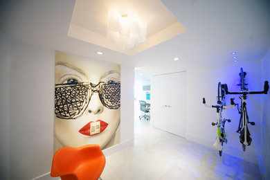 Photo of a contemporary foyer in Miami with white walls, limestone floors and a white front door.