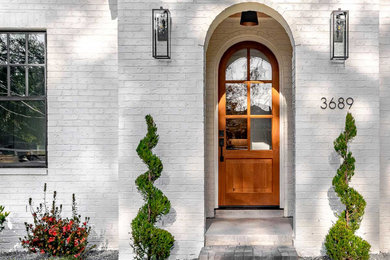 Example of a classic single front door design in Jacksonville with a medium wood front door