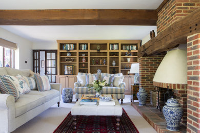 Inspiration for a large farmhouse formal open plan living room in Sussex with beige walls, carpet, a plastered fireplace surround, a corner tv, beige floors, exposed beams and a chimney breast.