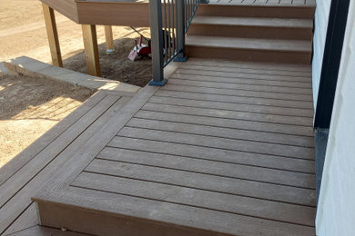 Deck - traditional backyard ground level metal railing deck idea in Other with a bbq area and no cover