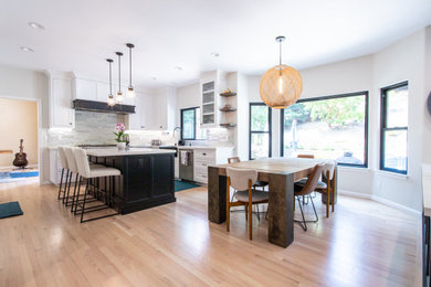 Mid-sized trendy brown floor kitchen/dining room combo photo in San Francisco with a standard fireplace and a tile fireplace