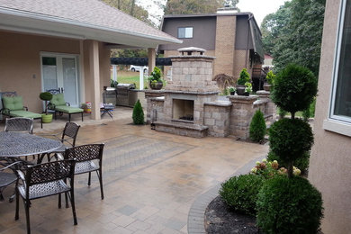 Photo of a mid-sized arts and crafts backyard patio in Baltimore with a fire feature and concrete pavers.