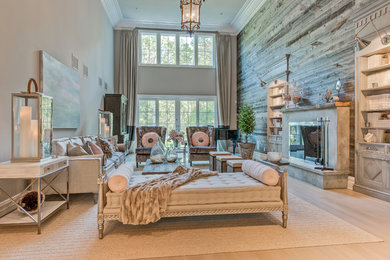 Example of a large beach style formal and open concept light wood floor and multicolored floor living room design in New York with gray walls, a standard fireplace, a concrete fireplace and no tv