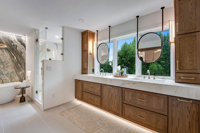 Inspiration for a huge transitional master white tile and stone slab porcelain tile, beige floor, double-sink and wall paneling bathroom remodel in Denver with recessed-panel cabinets, medium tone wood cabinets, a two-piece toilet, white walls, an integrated sink, solid surface countertops, a hinged shower door, white countertops and a floating vanity