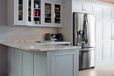 Kitchen - large transitional kitchen idea in New York with a farmhouse sink, flat-panel cabinets, blue cabinets, quartz countertops, stainless steel appliances, a peninsula and beige countertops