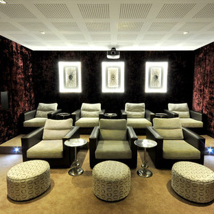 Design ideas for a large contemporary enclosed home cinema in Other with red walls, carpet, a projector screen and green floors.