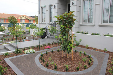 Photo of a mid-sized mediterranean front yard full sun formal garden in Melbourne with gravel and a metal fence.