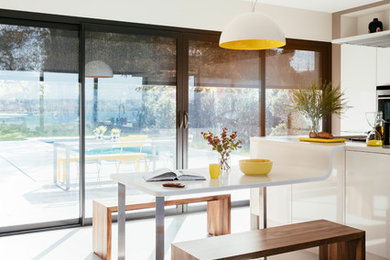 Modern eat-in kitchen in Sydney with white cabinets, with island and white floor.