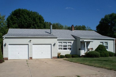 Example of a green one-story vinyl exterior home design in Other