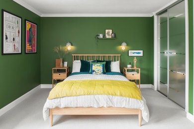 Photo of a large contemporary guest bedroom in Hertfordshire with green walls, carpet and feature lighting.