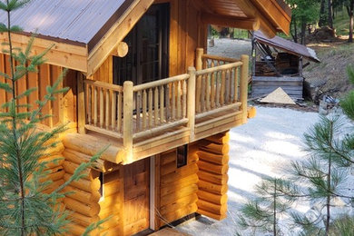 Inspiration for a mid-sized rustic brown two-story wood exterior home remodel in Seattle with a metal roof