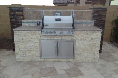 Mid-sized backyard tile patio kitchen photo in Phoenix with no cover