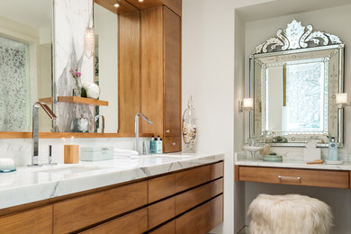 Design ideas for a contemporary master bathroom in Toronto with flat-panel cabinets, medium wood cabinets, beige tile, white walls, an undermount sink, marble benchtops and marble floors.