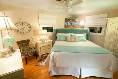 Small eclectic master light wood floor bedroom photo in Cleveland with beige walls and no fireplace