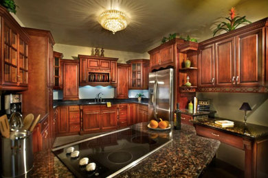 Eat-in kitchen - mid-sized traditional u-shaped cement tile floor eat-in kitchen idea in Boise with a double-bowl sink, raised-panel cabinets, dark wood cabinets, granite countertops, stainless steel appliances and a peninsula