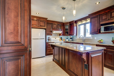 Example of a mid-sized transitional l-shaped porcelain tile eat-in kitchen design in Montreal with an undermount sink, raised-panel cabinets, dark wood cabinets, granite countertops, beige backsplash, mosaic tile backsplash, white appliances and an island