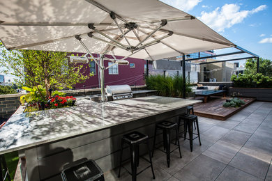 Inspiration for a large contemporary rooftop outdoor kitchen deck remodel in Chicago