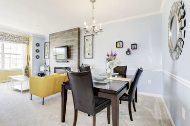 Inspiration for a mid-sized transitional carpeted and gray floor dining room remodel in Raleigh with blue walls, a standard fireplace and a tile fireplace