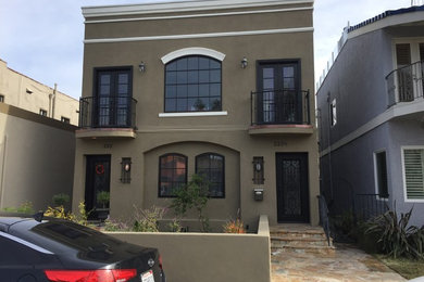 Mid-sized contemporary brown two-story stucco flat roof idea in Los Angeles