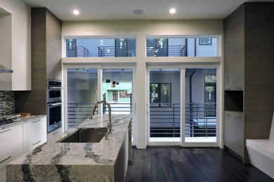 Example of a trendy dark wood floor eat-in kitchen design in Philadelphia with a single-bowl sink, flat-panel cabinets, medium tone wood cabinets, quartz countertops, multicolored backsplash, ceramic backsplash, stainless steel appliances, an island and multicolored countertops