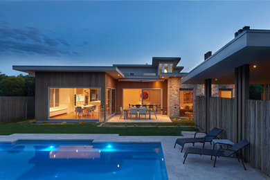 Large contemporary backyard rectangular lap pool in Melbourne with concrete slab.