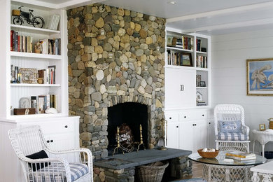 Beach style living room photo in Boston with a stone fireplace