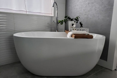 Example of a mid-sized minimalist freestanding bathtub design in Seattle